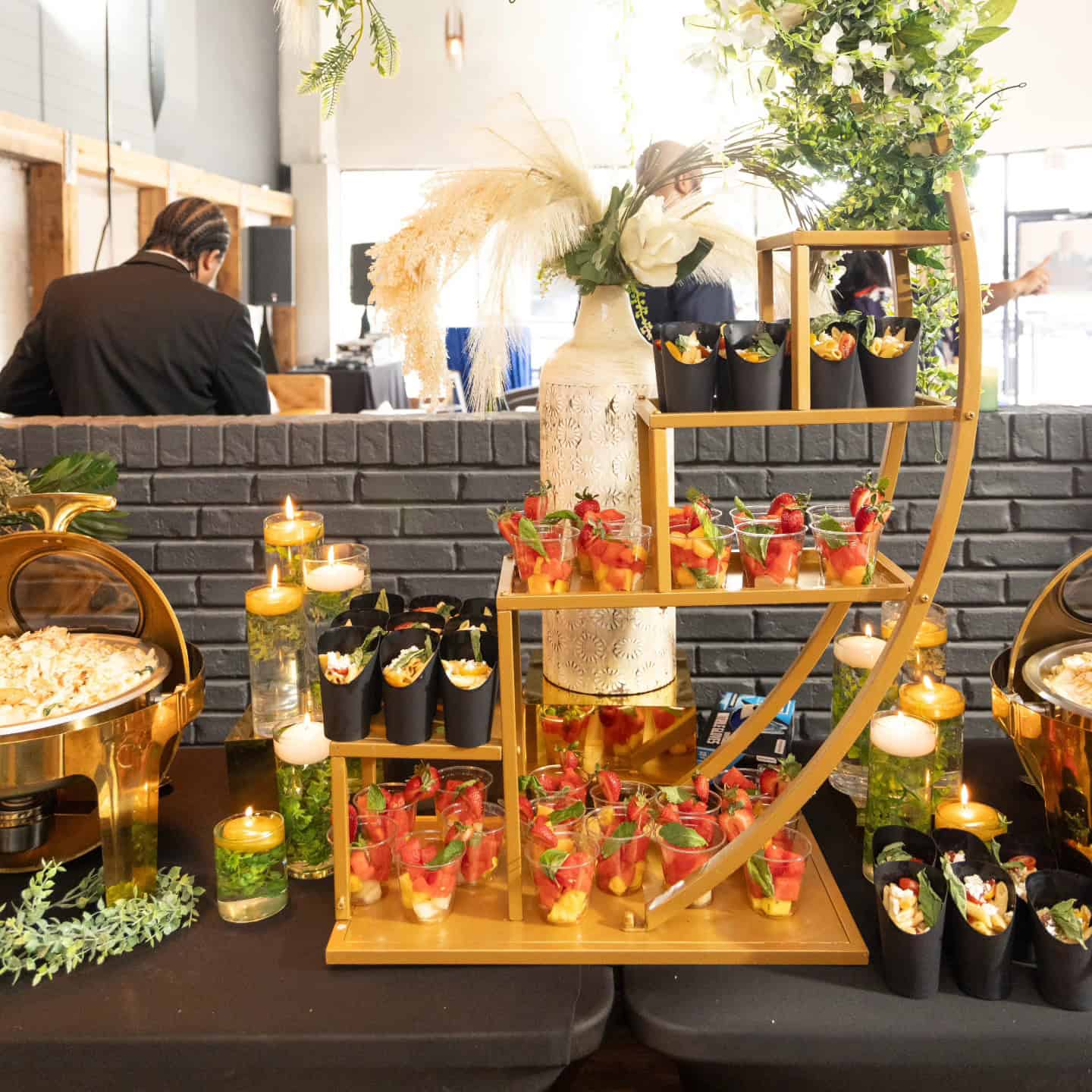 Catering display with desserts and drinks at an event.