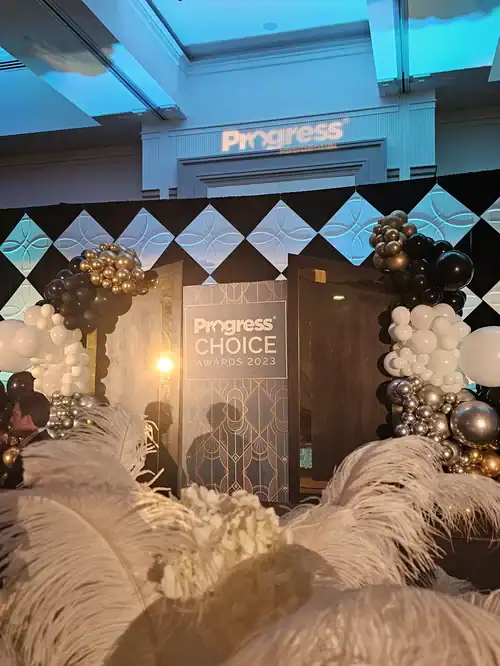 Elegant awards event setup with balloons and stage for Angela J. White Consulting.