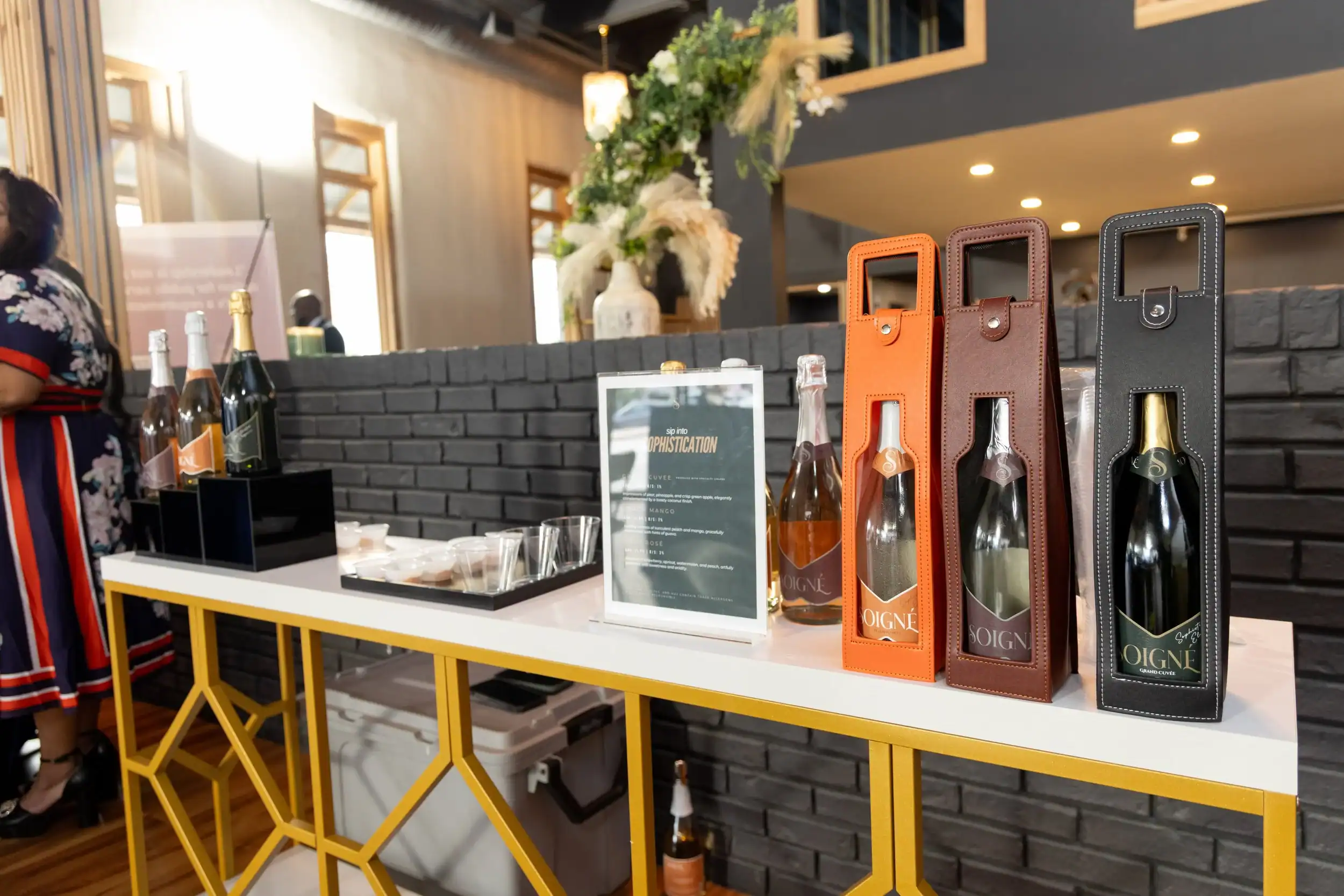 Display of wine bottles in colorful boxes at Angela J. White Consulting event.