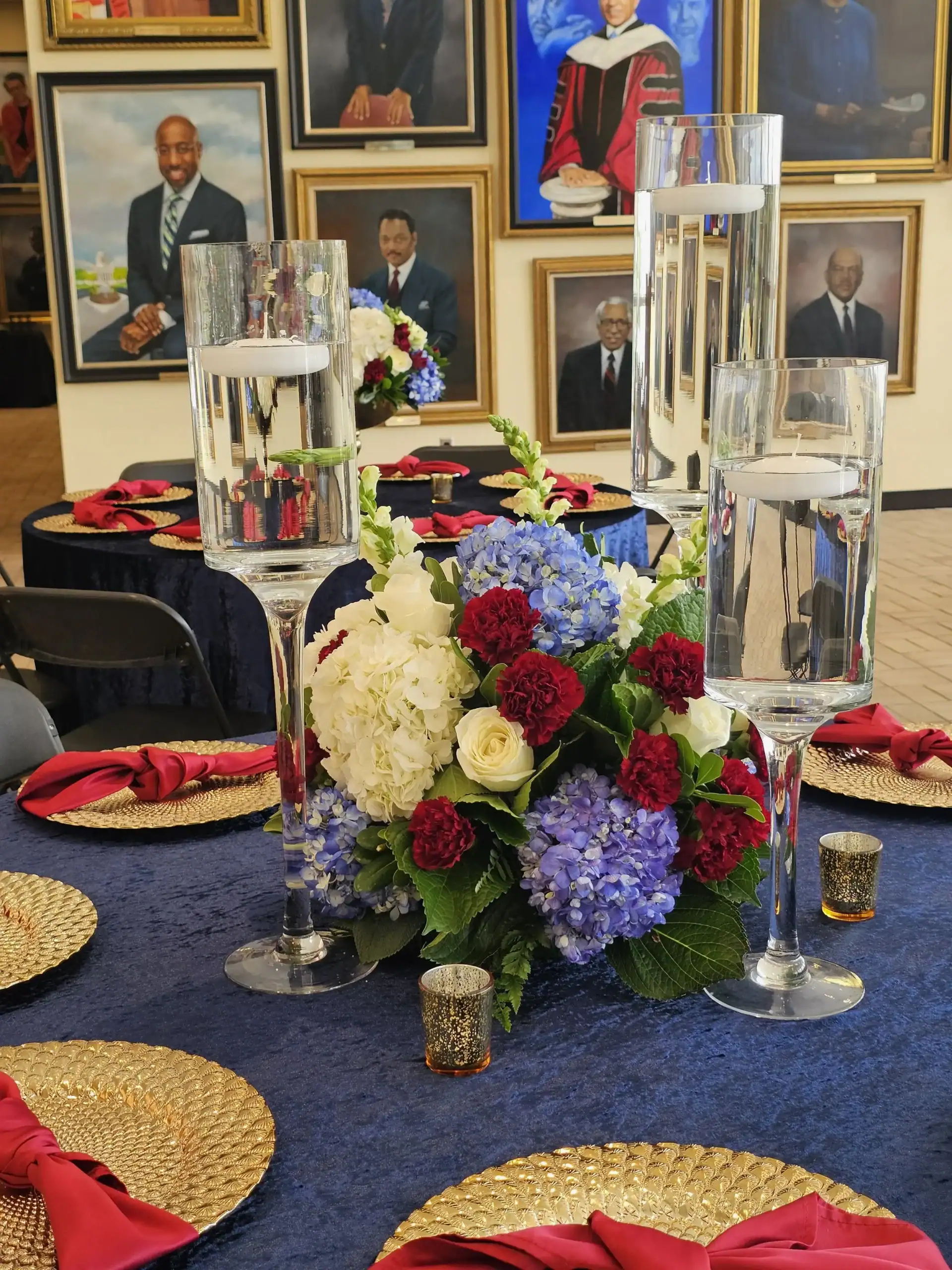Decorated event table with floral centerpiece and water glasses for Angela J. White Consulting.