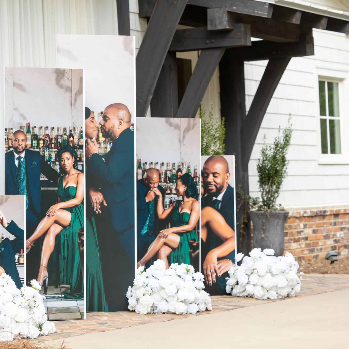 Event display with large photos of people at Angela J. White Consulting.