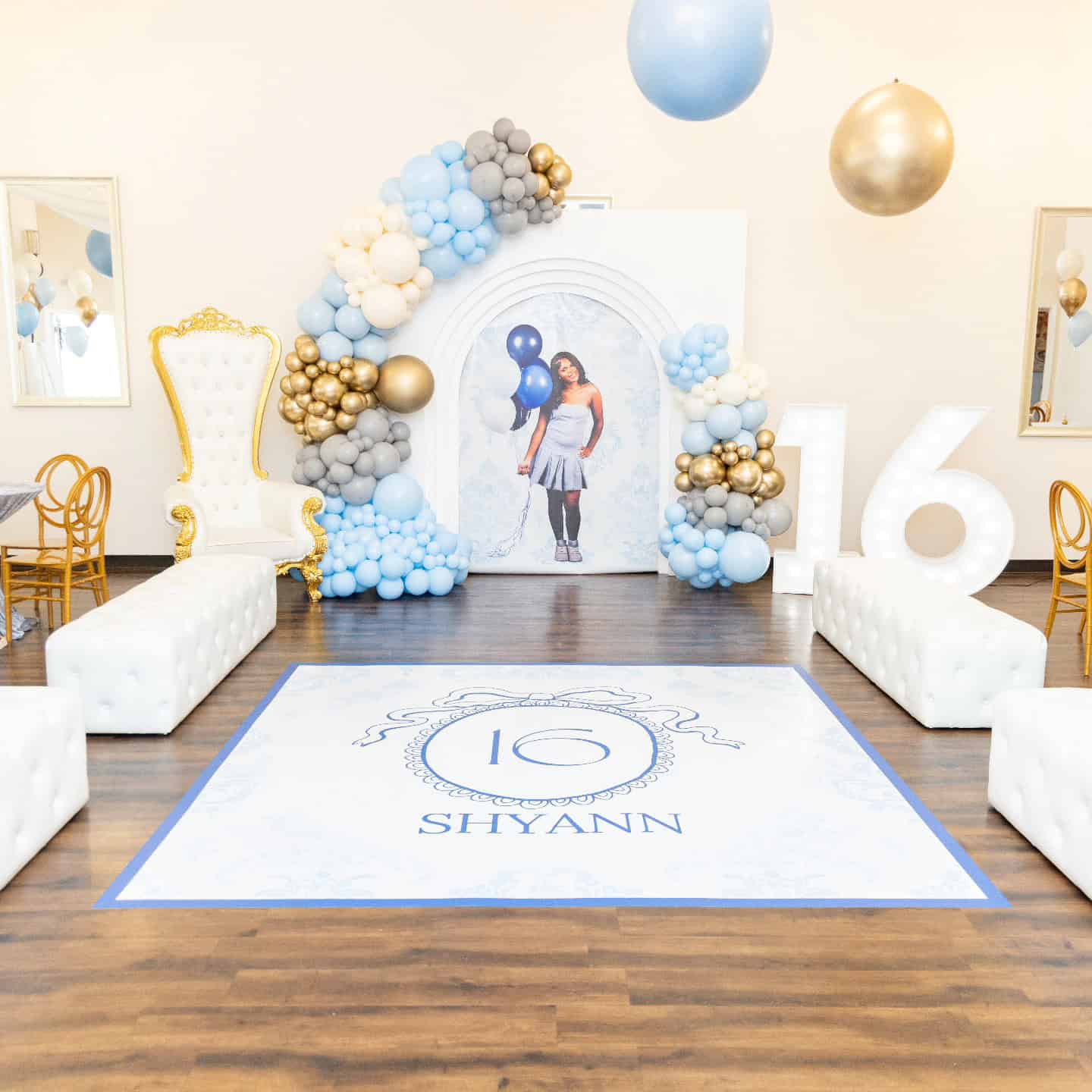 Elegant event setup with balloon arch and personalized floor design for Shyann's 16th birthday.
