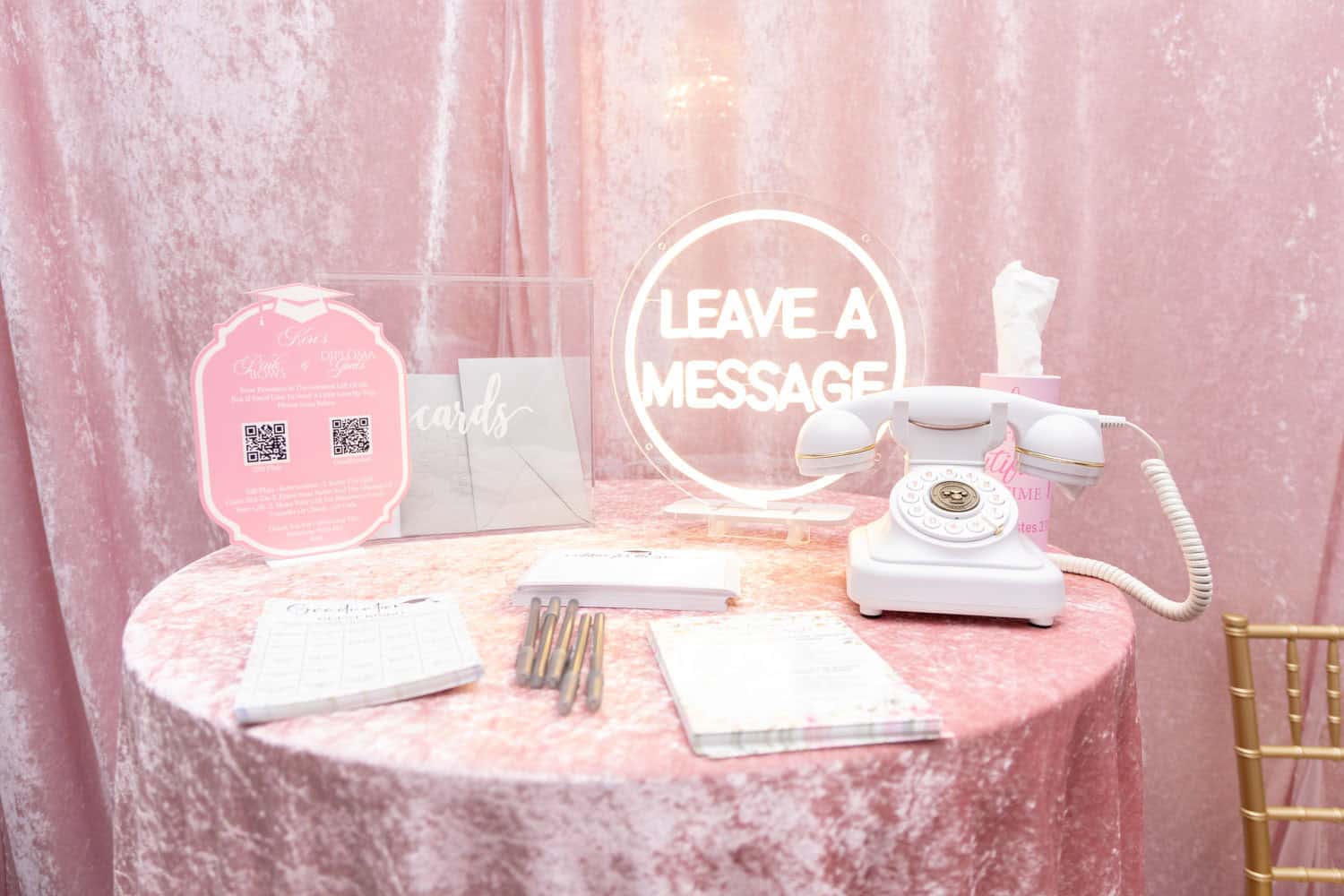 Decorative office desk with vintage rotary phone and motivational signs.