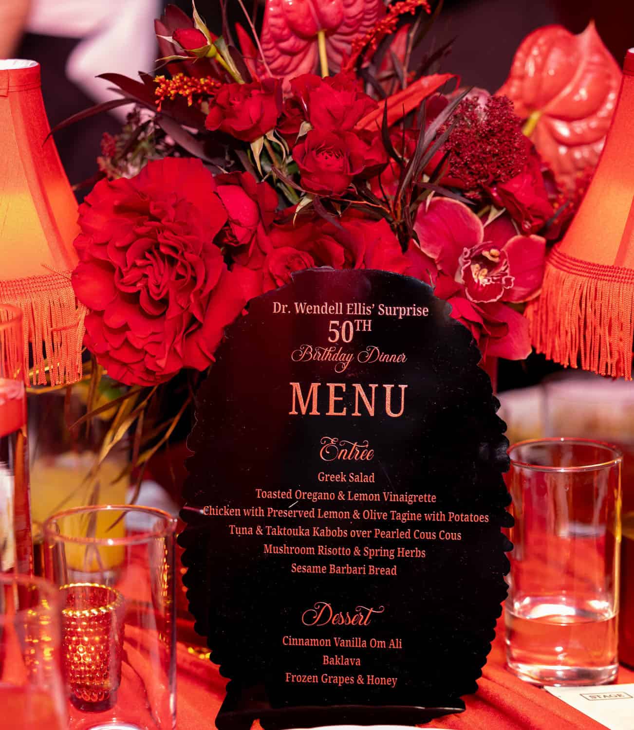 Elegant birthday celebration with red floral decor and menu for Dr. Wendell Ellis' 50th birthday.