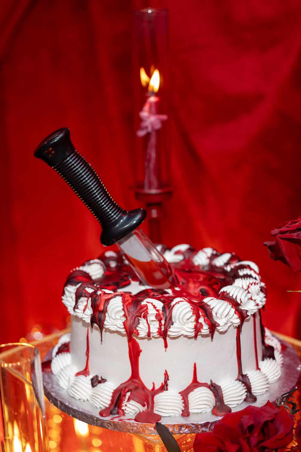 Decorative Valentine's Day cake with knife and candle for celebration.