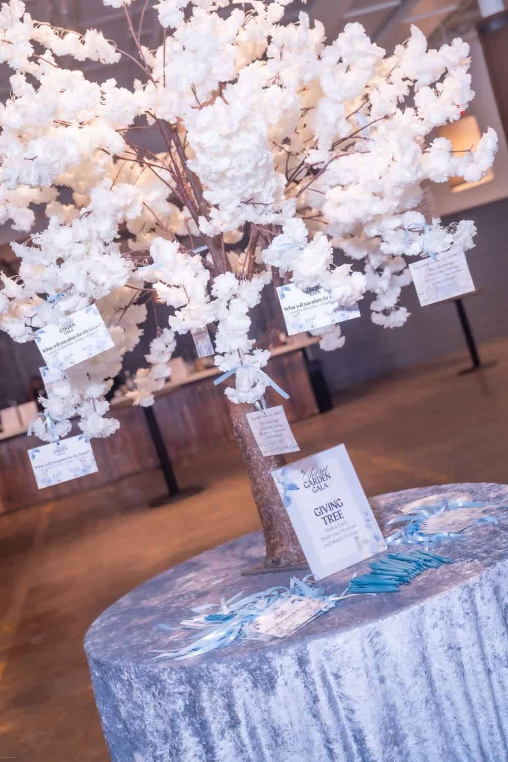 Beautiful white cherry blossom tree with informational tags at Angela J. White Consulting.