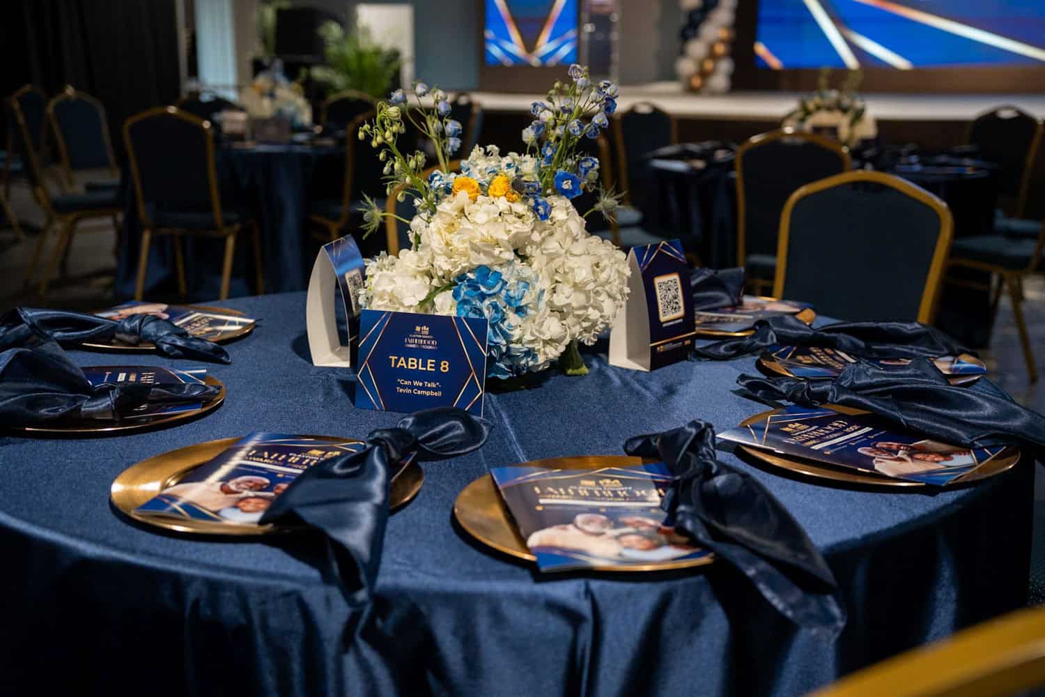 Formal event table with floral centerpiece and place settings for a corporate gala.