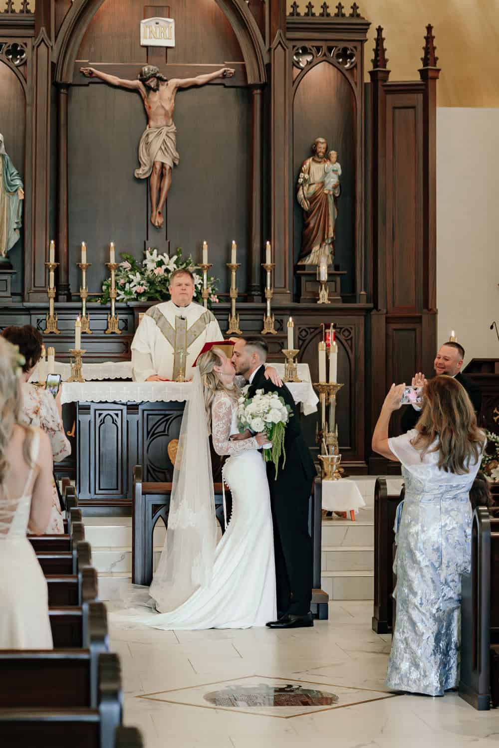 Bride and groom exchanging vows at church altar during wedding ceremony.