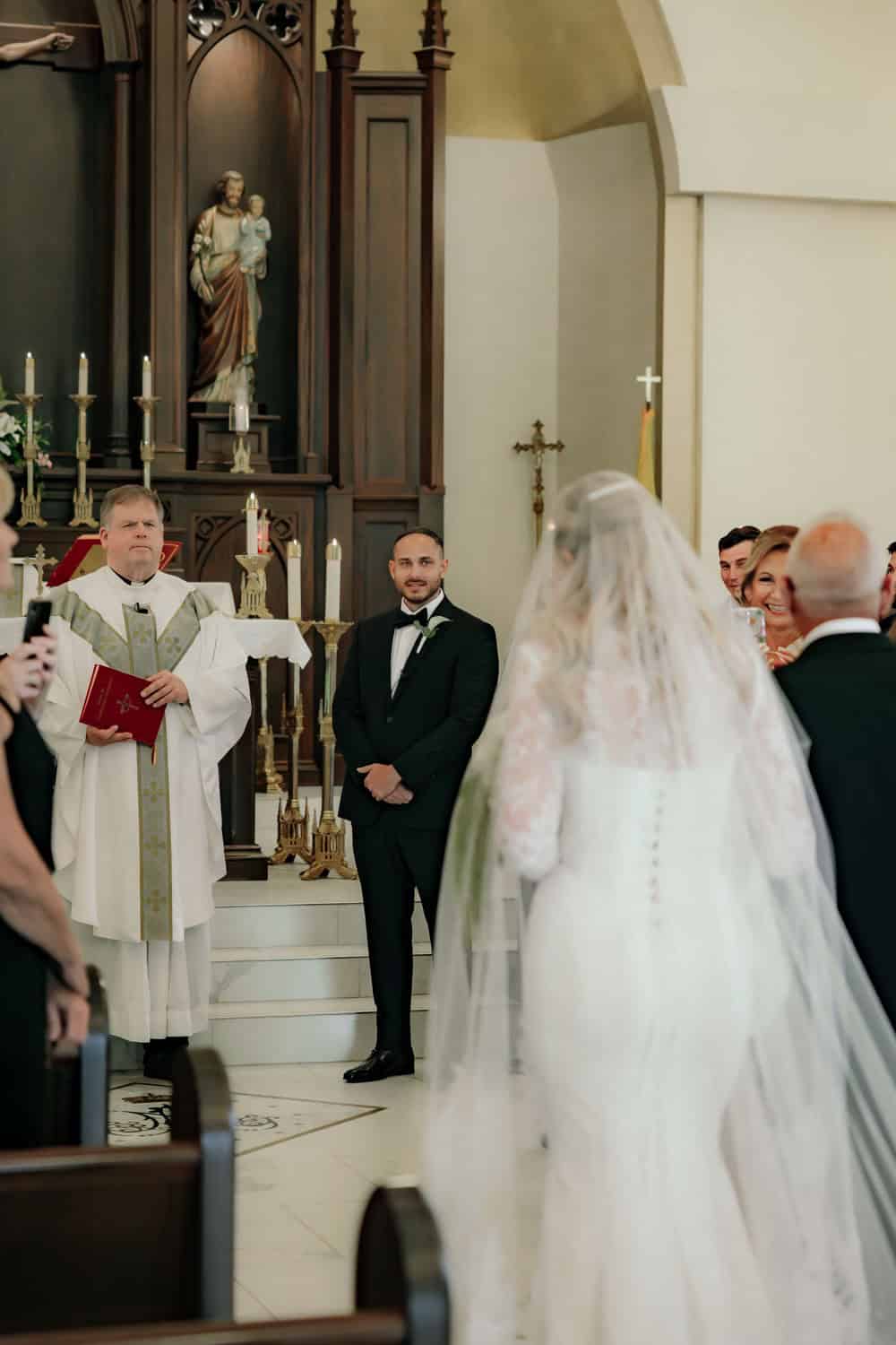 Bride and groom during wedding ceremony in church setting.