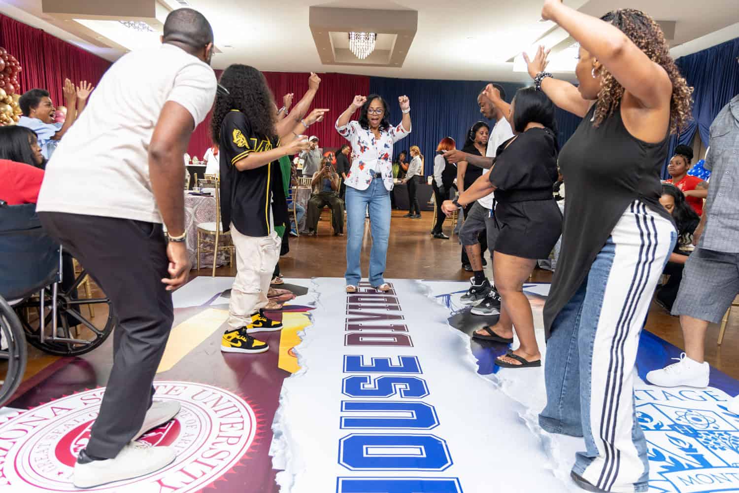 People dancing and celebrating at Angela J. White Consulting event.