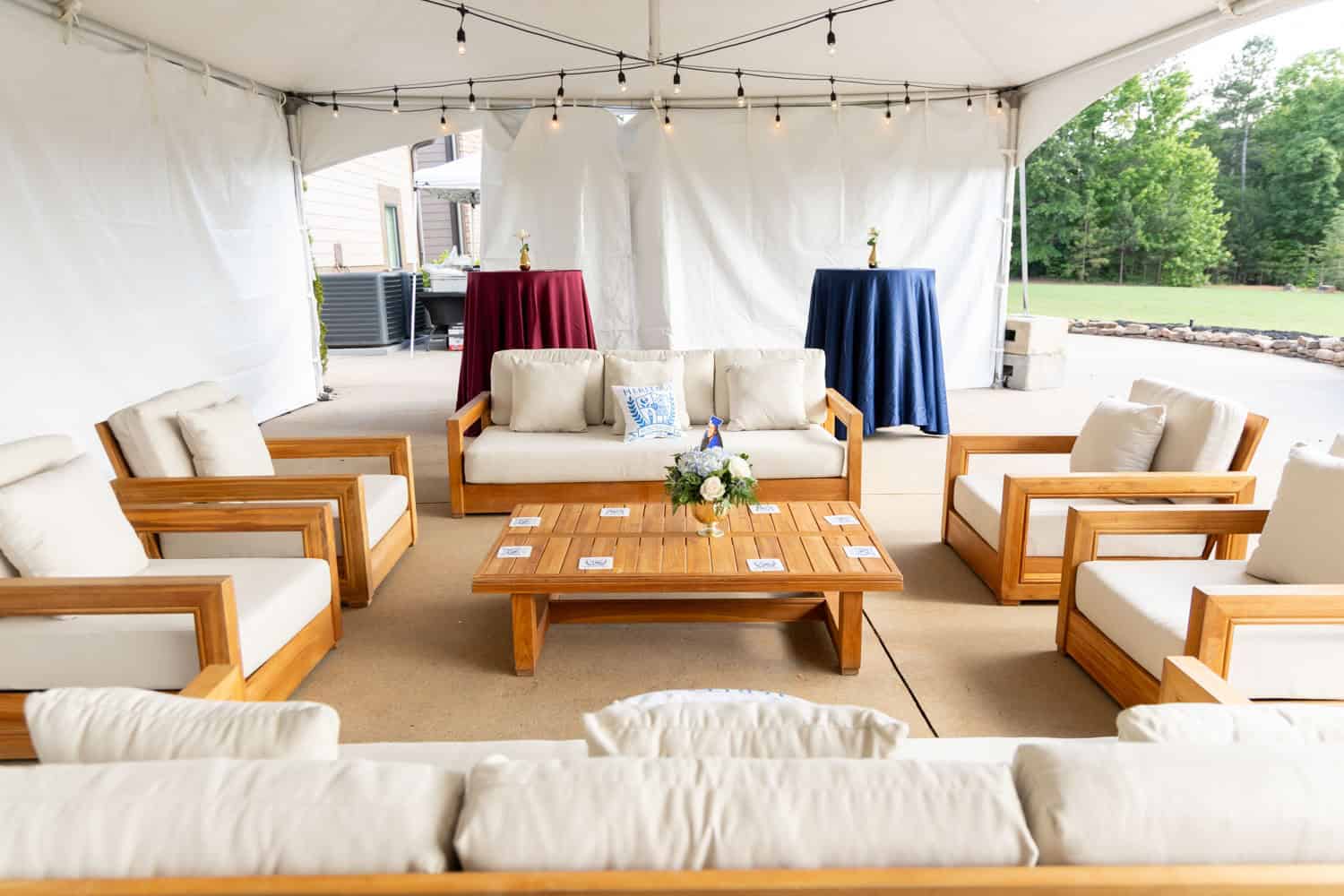 Outdoor event space with comfortable seating and string lights for networking.