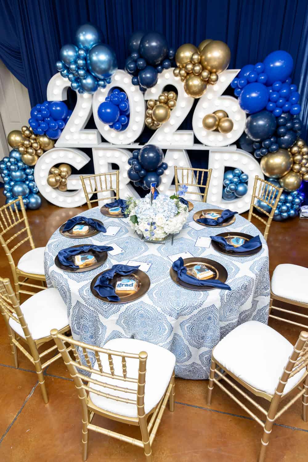 Decorative table with balloons and '2024' sign for New Year event.