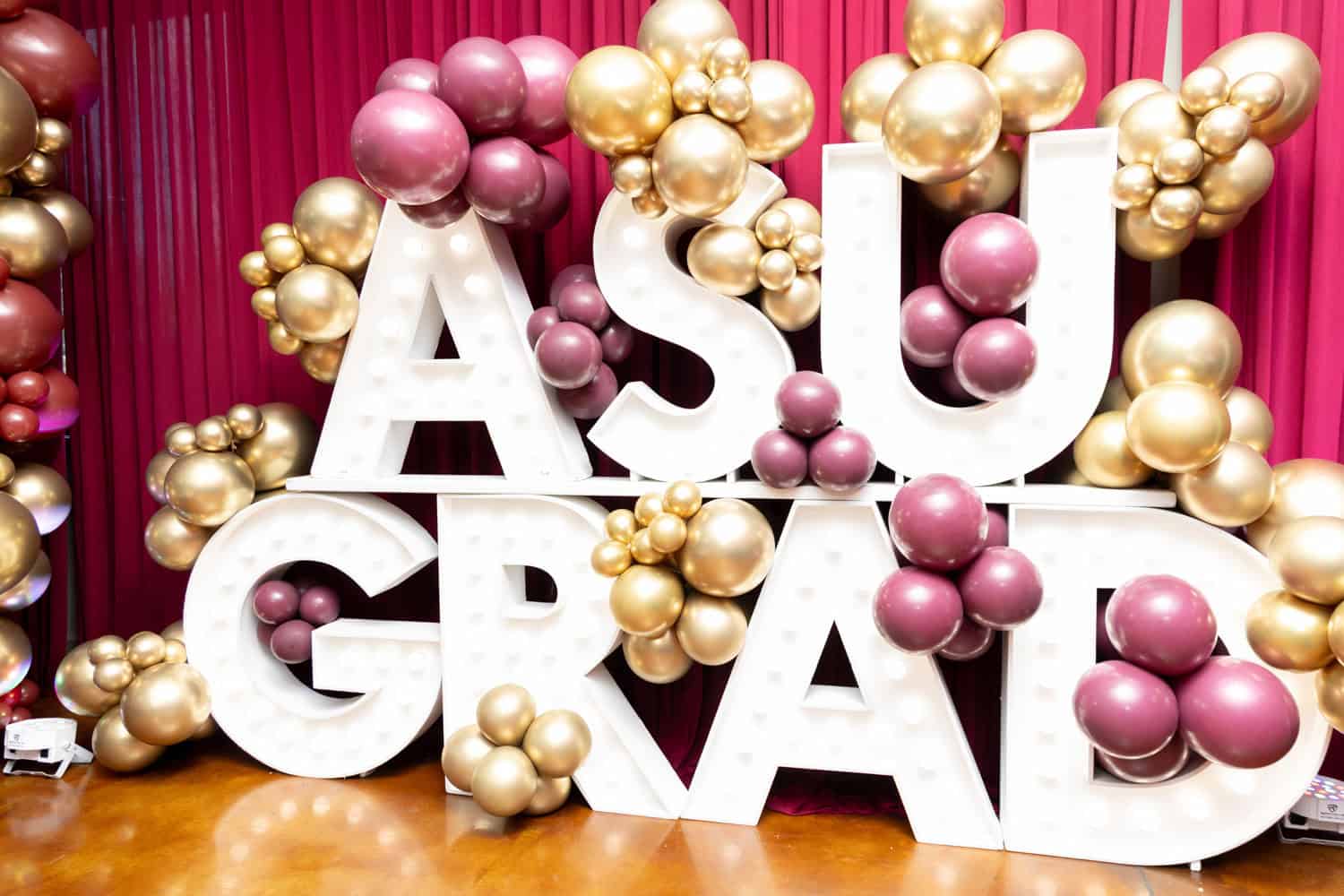 ASU graduation celebration with balloons and large letters.